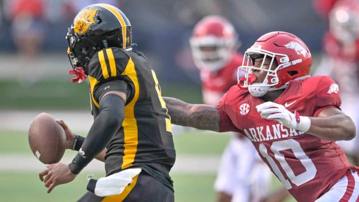 Arkansas Razorbacks linebacker Xavian Sorey reaches out to grab UAPB Golden Lions quarterback Mekhi Hagens during Thursday night's game at War Memorial Stadium in Little Rock, Ark.