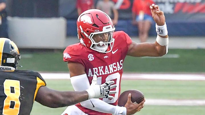 Arkansas Razorbacks quarterback Taylen Green dodges a tackler against UAPB in War Memorial Stadium in Little Rock, Ark.