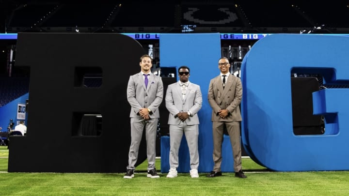 Jonah Coleman is surrounded by Carson Bruener and Kamren Fabiculanan at Big Ten Media Days. 