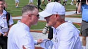 Sep 20, 2025; Blacksburg, Virginia, USA;  Virginia Tech Hokies head coach Phillip Montgomery and Wofford Terriers head coach Shawn Watson shake hands after the game at Lane Stadium. Mandatory Credit: Brian Bishop-Imagn Images