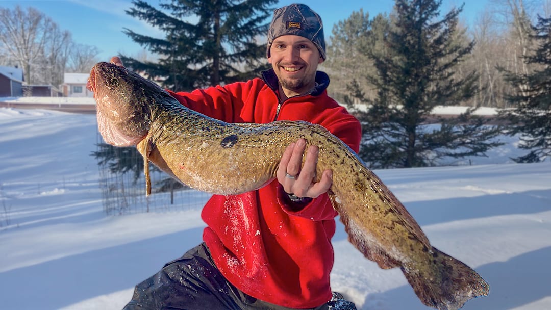 Jon Kroll of Ashland, Wis., displays a 14-pound Lake Superior eelpout. This fish is longer than the existing state record, but came up a little short of record weight.