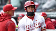 Arkansas Razorbacks shortstop coming to plate and talking with hitting coach Nate Thompson during game against Washington State.