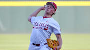 Arkansas Razorbacks pitcher Tate McGuire delivers a throw to the plate against the Little Rock Trojans at Baum-Walker Stadium in Fayetteville, Ark.
