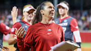 Arkansas Razorbacks coach Courtney Deifel walks to the dugout after knocking off the Ole Miss Rebels in an NCAA Super Regional at Bogle Park