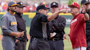 Tennessee Volunteers coach Tony Vitello and Arkansas Razorbacks coach Dave Van Horn go over ground rules with umpires before their game at Baum-Walker Stadium in Fayetteville, Ark.