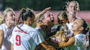 Arkansas Razorbacks forward Zoe Susi mobbed by teammates after penalty kick for draw against the No. 2 Notre Dame Fighting Irish in Fayetteville, Ark.