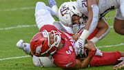 Arkansas Razorbacks quarterback Taylen Green is brought down by Texas A&M defenders in game at Razorback Stadium in Fayetteville, Ark.