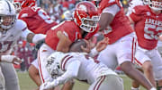 Arkansas Razorbacks quarterback Taylen Green tackled by a Mississippi State defender during a game at Razorback Stadium in Fayetteville, Ark.