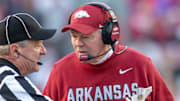 Arkansas Razorbacks interim coach Bobby Petrino talking to an official during game against the Mississippi State Bulldogs at Razorback Stadium in Fayetteville, Ark.