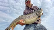 The author hefts his personal best lake trout, caught while downrigger fishing on Lake Superior.