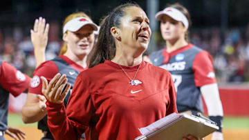 Arkansas Razorbacks coach Courtney Deifel walks to the dugout after knocking off the Ole Miss Rebels in an NCAA Super Regional at Bogle Park