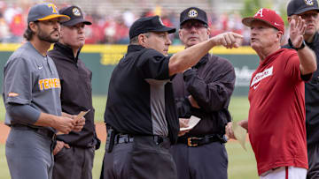 Tennessee Volunteers coach Tony Vitello and Arkansas Razorbacks coach Dave Van Horn go over ground rules with umpires before their game at Baum-Walker Stadium in Fayetteville, Ark.