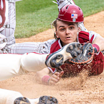 Arkansas Razorbacks Cam Kozeal is tagged out trying to score by South Carolina Gamecocks catcher Gavin Braland in their game at Baum-Walker Stadium in Fayetteville, Ark.