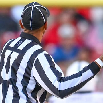 An official prepares to throw a flag in the Arkansas Razorbacks game against the Mississippi State Bulldogs at Razorback Stadium in Fayetteville, Ark.