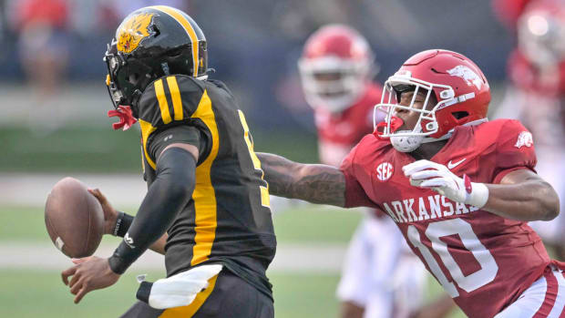 Razorbacks linebacker Xavian Sorey reaches out to grab UAPB Golden Lions quarterback Mekhi Hagens