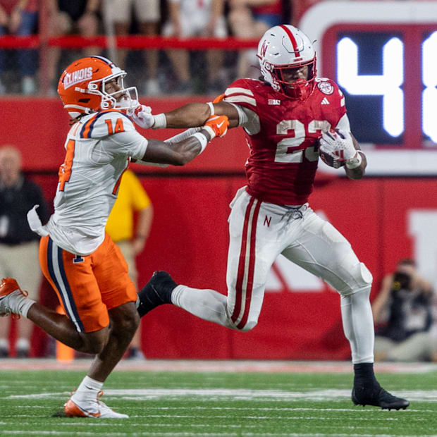 Nebraska running back Dante Dowdell rushes for a 9-yard gain against Illinois.