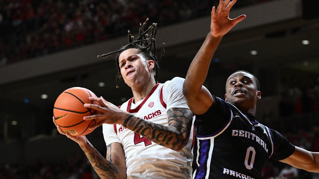 Arkansas Razorbacks forward Trevon Brazile grabs a rebound against UCA Bears Ubongabasi "Glory" Etim at Simmons Bank Arena in North Little Rock, Ark.