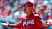 Arkansas Razorbacks coach Dave Van Horn reacting to a call in the field in a game.