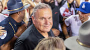 Arkansas Razorbacks coach Sam Pittman in swirl of fans rushing the field after a 19-14 win over No. 4 Tennessee at Razorback Stadium on Oct. 5, 2024.