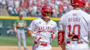 Arkansas Razorbacks' Cam Kozeal finishing after homer in an NCAA Regional game against the North Dakota State Bison at Baum-Walker Stadium in Fayettev