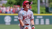 Arkansas Razorbacks' Logan Maxwell celebrates coming home after a grand slam homer against the Tennessee Volunteers in Fayetteville, Ark.