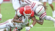 Arkansas Razorbacks running back Mike Washington is brought down a pair of Alabama A&M defenders in a game at Razorback Stadium in Fayetteville, Ark.