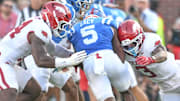 Arkansas Razorbacks defenders Stephen Dix and Larry Worth move in for a tackle of Ole Miss Rebels running back Kewan Lacy at Vaught-Hemingway Stadium in Oxford, Miss.