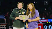 Taina Fernandez receives her Outstanding Wrestler award for her title in the 16U Nationals. She also won a Junior Nationals crown.