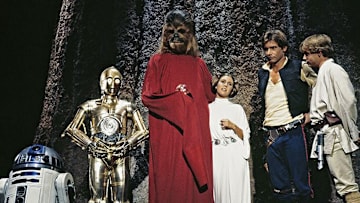 (L to r) R2-D2, Anthony Daniels as C-3PO, Peter Mayhew as Chewbacca, Carrie Fisher as Princess Leia, Harrison Ford as Han Solo, and Mark Hamill as Luke Skywalker in the Star Wars Holiday Special