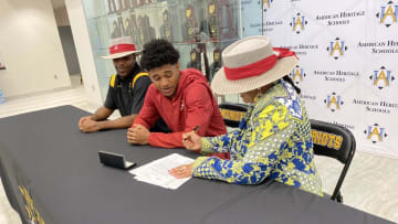 American Heritage star prospect Earl Little Jr. (center) signs with Alabama in a school ceremony on