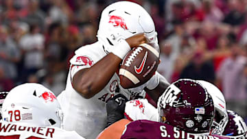 Arkansas Razorbacks quarterback KJ Jefferson tries to jump the Texas A&M Aggies but loses a fumble that was returned to the other side of AT&T Stadium in Arlington, Texas.