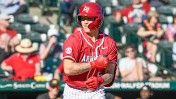 Arkansas Razorbacks designated hitter Kuhio Aloy trots to first base after drawing a walk against the Grambling Tigers at Baum-Walker Stadium.