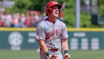 Arkansas Razorbacks' Logan Maxwell celebrates coming home after a grand slam homer against the Tennessee Volunteers in Fayetteville, Ark.