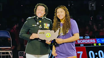 Taina Fernandez receives her Outstanding Wrestler award for her title in the 16U Nationals. She also won a Junior Nationals crown.
