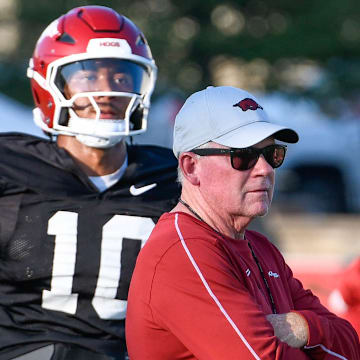 Arkansas Razorbacks offensive coordinator Bobby Petrino working with quarterback Taylen Green at Saturday's practice on the outdoor fields in Fayetteville, Ark.