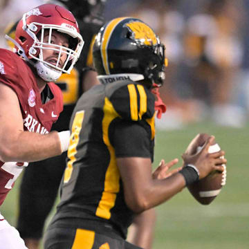 Arkansas Razorbacks defensive lineman Anton Juncaj chases UAPB quarterback Mekhi Hagens in their game at War Memorial Stadium in Little Rock, Ark.