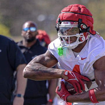 Arkansas Razorbacks running back Mike Washington carries the ball during a drill at spring practice on the outdoor fields in Fayetteville, Ark.