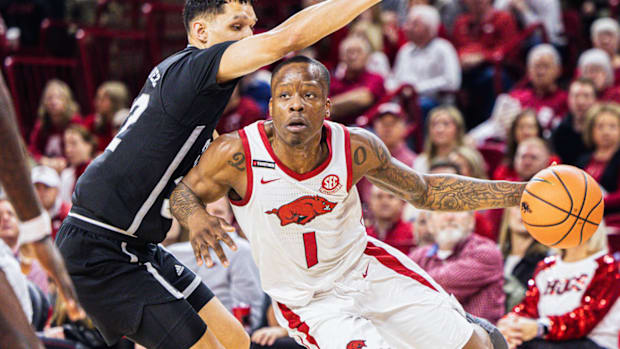 Razorbacks guard Johnell Davis drives past a Mississippi State defender