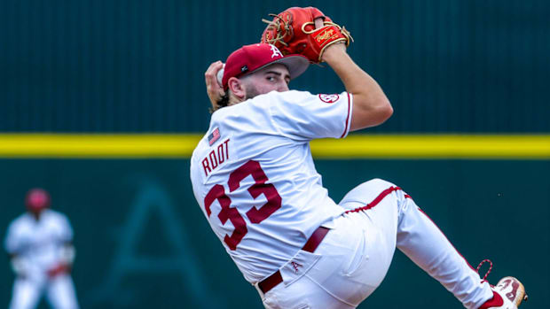 Razorbacks pitcher Zach Root winds to throw a pitch against Tennessee