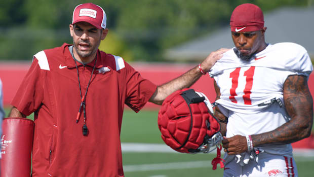Arkansas Razorbacks wide receivers coach Ronnie Fouch with Monte Harrison during a break between drills