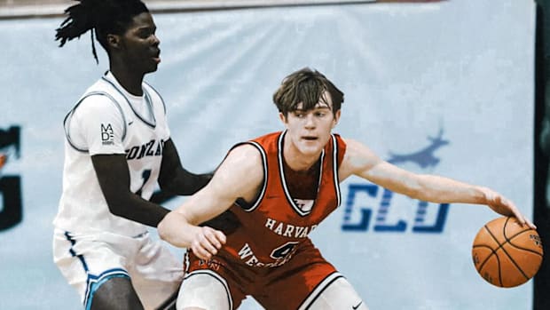 Harvard-Westlake senior Nikolas Khamenia (4) protects his dribble against the defense of Gonzaga’s Saxton Smiley (1).