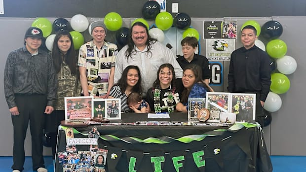 The Fawcett family poses for photos after Amelia Fawcett signed her letter of intent to wrestle for Life University.