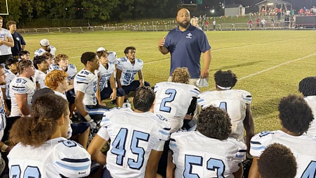 Stone Bridge head coach Kendric Golston addresses his team following its 20-0 loss to Quince Orchard