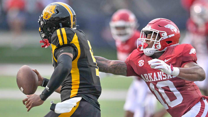 Arkansas Razorbacks linebacker Xavian Sorey reaches out to grab UAPB Golden Lions quarterback Mekhi Hagens during Thursday night's game at War Memorial Stadium in Little Rock, Ark.