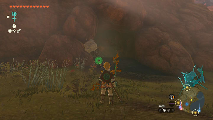 Link standing at the entrance to a cave.