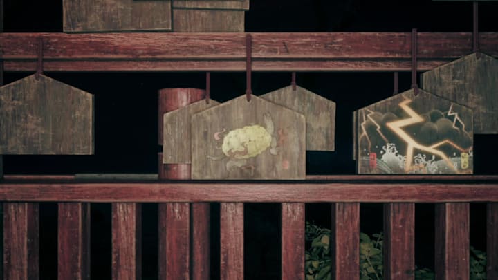 A wooden ema adorned with an upside-down tortoise in Silent Hill f