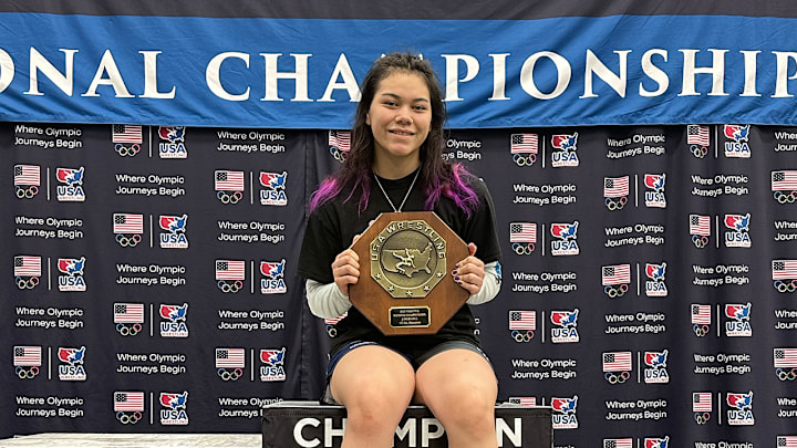 Amelia Fawcett holds her first big stop sign in Des Moines Iowa after winning the 155-pound weight class at the Junior Folkstyle National Championships.