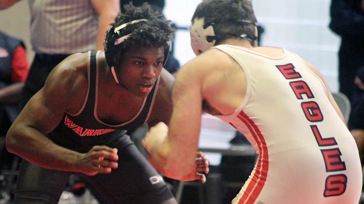 Thompson's Braylen Johnson (left) squares off against Oak Mountain's Jaxon Briggs, who he later pinned, in the 115-pound match in the AHSAA Class 7A State Duals finals. Johnson was one of five Thompson wrestlers to go 3-0 in the event as the Tommies topped Oak Mountain, 33-28, for the title.