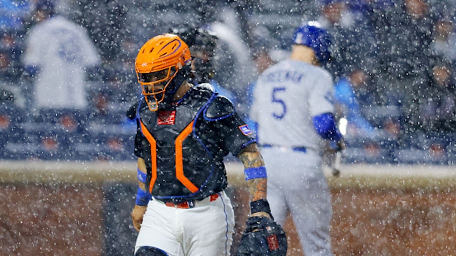 Mets catcher Francisco Alvarez walks off the field during a rain delay against the Los Angeles Dodgers.  | Photo by Mike Stobe / Getty Images