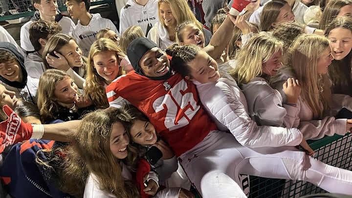 Archbishop Spalding senior defensive back Alijah Jones celebrates the third consecutive MIAA A Conference football championship with fans in the Spalding section, Saturday night at Calvert Hall.